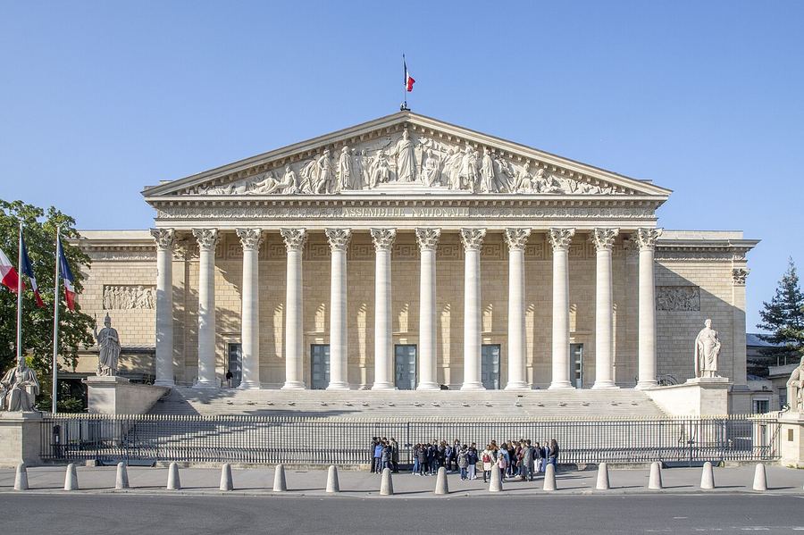 Archive: façade of the Palais Bourbon in Paris — 17 May 2023 (ZeusUpsistos, CC BY-SA 4.0). Not the 18 September 2026 Public exclusive, not Bothorel’s interview, not the Paris prosecutor’s office raid on X, and not Assemblée debate day-of photography.