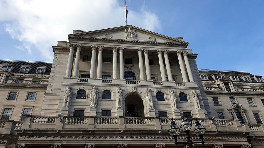 Archive: Street-level facade of the Bank of England on Threadneedle Street, London — columns and portico (Michael / Bacon Noodles, public domain per Commons). Not the 18 September 2026 Gate 2 SAN issuance ceremony, not ClearToken executives day-of, not a DSS dashboard screenshot, and not live settlement-floor photography.