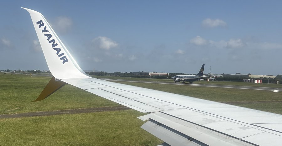 Archive photo: Ryanair jets queue for take-off at Dublin Airport, seen from the wing of another Ryanair plane, in July 2026.