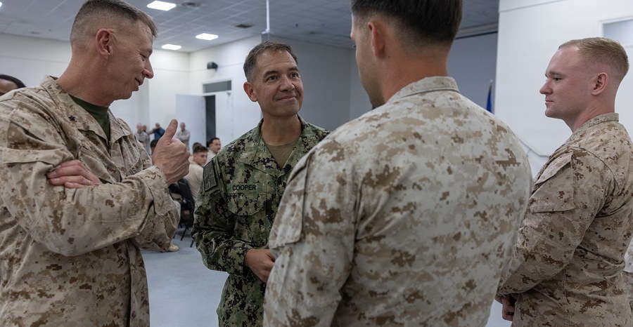 Adm. Brad Cooper (second from left), head of U.S. Central Command, greets Marines who supported the mine clearance mission in the Strait of Hormuz in October 2026.